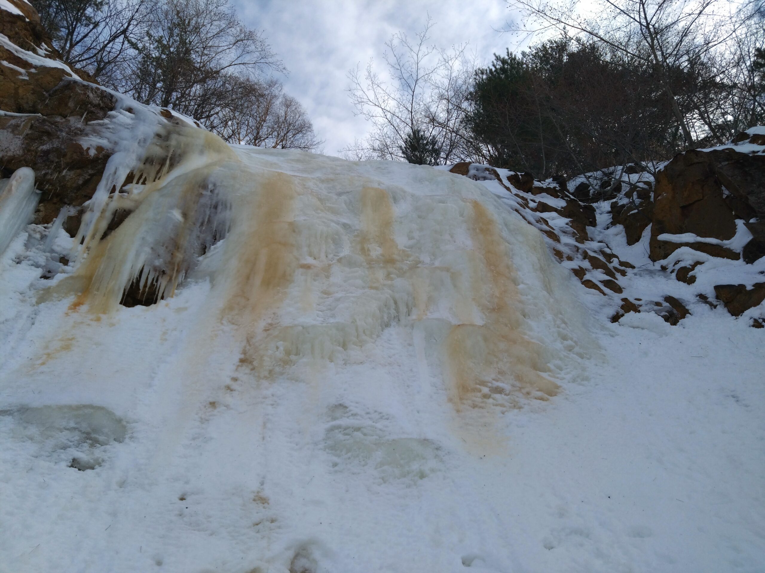 While the snow monsters in Aomori and Akita present challenges in the access, those in Yamagata pose a different issue — over-tourism. Due to its much easier access from Tokyo, Zao in Yamagata becomes heavily crowded in winter, as tourists flock to see the snow monsters. Zao also has a ropeway leading to the snow monsters even for non-hikers, but as you might expect, it gets extremely busy. The region boasts fantastic Onsen and high-quality inns, yet securing accommodations during winter can be difficult due to the capacity and the price-tag. Don’t get me wrong — I personally love Zao, but I’m not entirely confident that my guests would enjoy their experience there due to the mismatch between its breathtaking natural scenery and the worldly frustrations.<br />
<br />
Mt. Nishi-Azuma is my favorite snow monster hunting location — one I once wanted to keep secret. It is not far from Zao and offers even better access from Tokyo. Nishi-Azuma also has a gondola and chairlifts access close to the snow monster viewing area. From the top of the chairlifts, you’ll find yourself surrounded by snow monsters after just 30 minutes of snowshoeing.<br />
The allure of Nishi-Azuma lies in its so-called Little Monsters. Compared to other locations, the formations are relatively smaller and more broadly distributed. Their shapes resemble tentacles, creating a scene that feels more charming than mysterious.<br />
<br />
For accommodations, staying in Yonezawa or Onogawa Onsen for a couple of days allows flexibility in choosing Nishi-Azuma or Zao, depending on the weather. If an extra day is available, snowshoeing to Yellow Fall on Mt. Bandai is a fantastic option — where a sulfur-rich waterfall freezes into a striking spectacle.<br />
Kitakata City is located on the way to Mt. Bandai and is well-known as a 'Ramen City.' With around 60 ramen shops, Kitakata's signature ramen features curly noodles, a soy sauce-based broth, and tender roasted pork. If you're a ramen fan, you might want to try more than one! <br />
<br />
Yonezawa also offers museums and sake breweries, making it hard to choose where to go, even when the weather doesn’t cooperate. 02